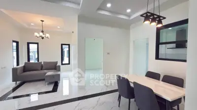 Modern open-plan living and dining area with elegant marble flooring and stylish lighting.