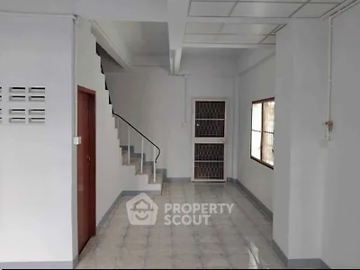 Spacious interior with staircase and tiled flooring, ideal for modern living.