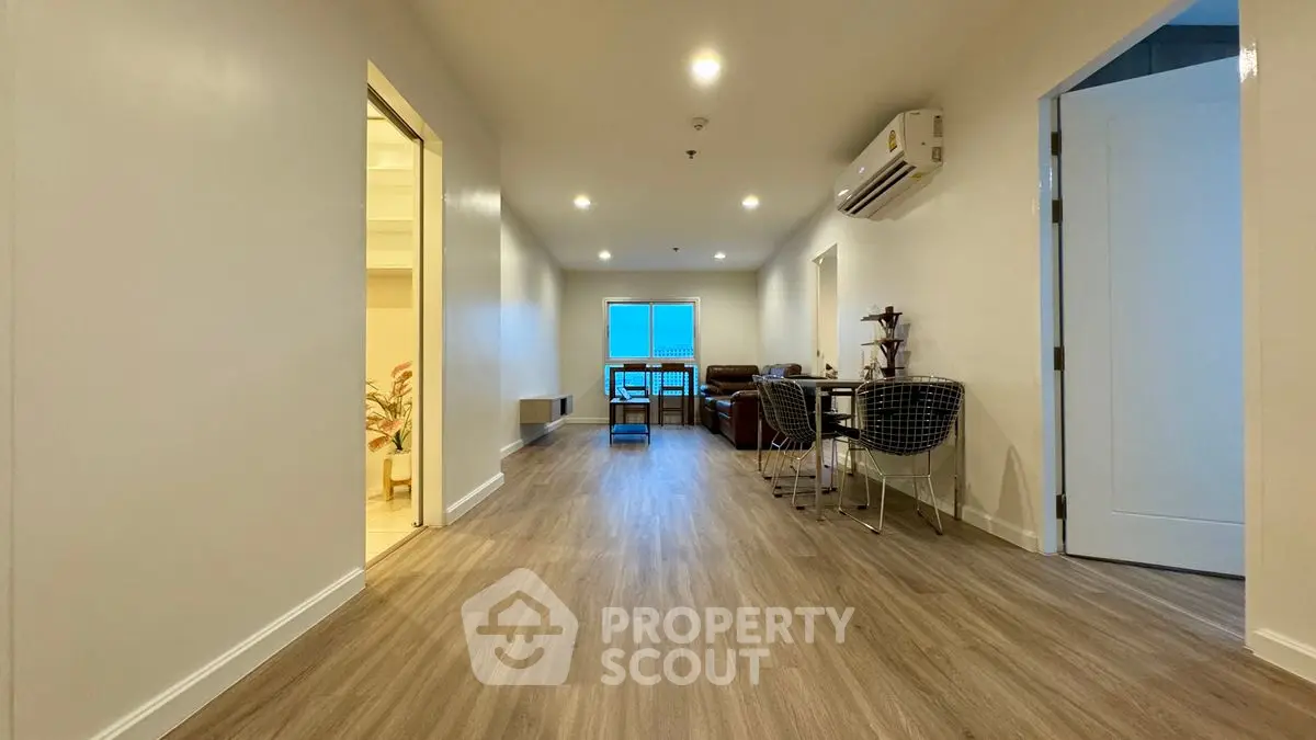 Spacious modern living area with sleek flooring and stylish furniture