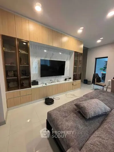 Modern bedroom with built-in entertainment unit and sleek design