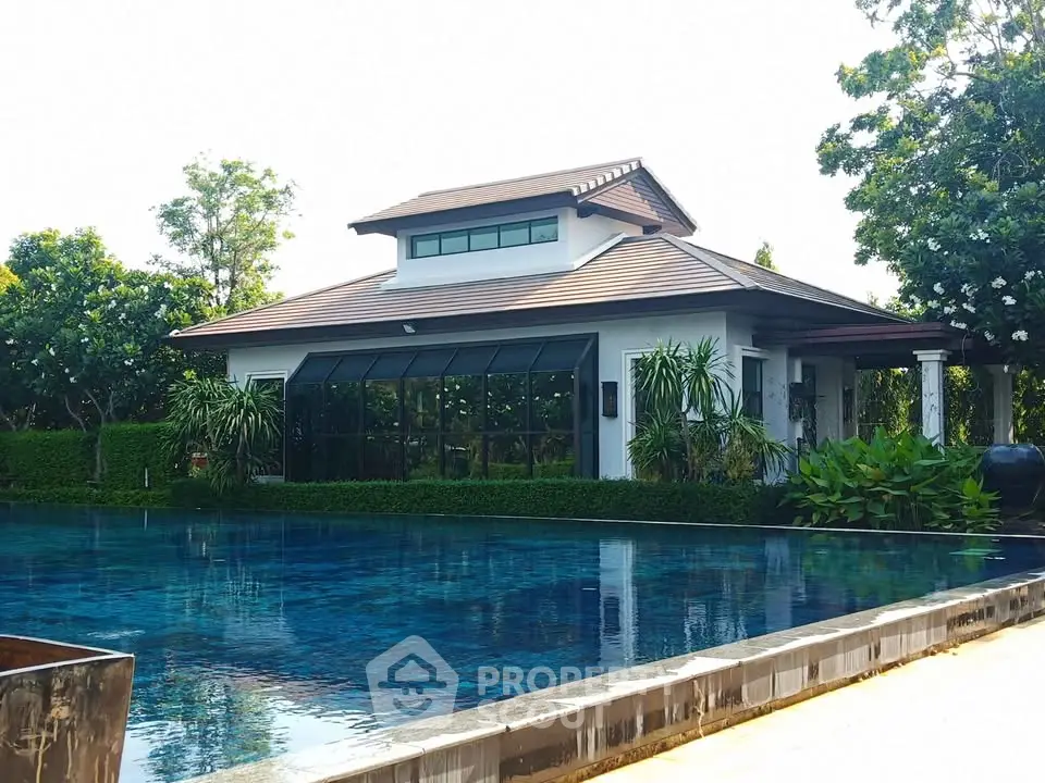 Luxurious villa with stunning pool and lush greenery, perfect for serene living.