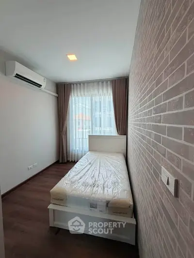 Cozy bedroom with brick accent wall and natural light
