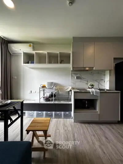 Modern kitchen with sleek cabinetry and open layout in stylish apartment