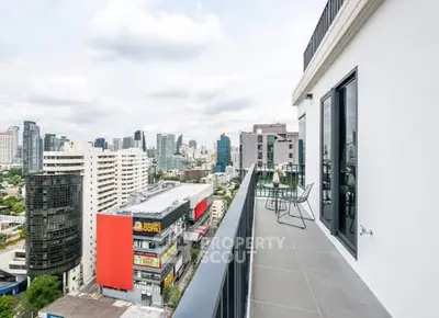 Stunning cityscape view from a modern high-rise balcony with sleek design.