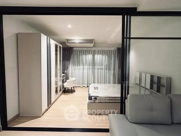 Modern bedroom with glass partition and stylish furnishings