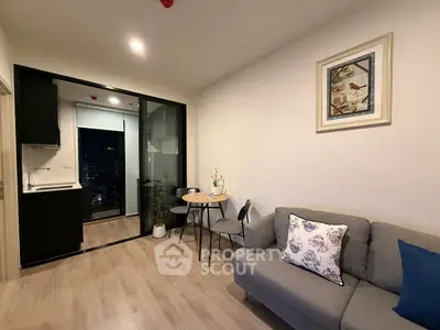 Modern living room with cozy sofa and dining area in open layout apartment.