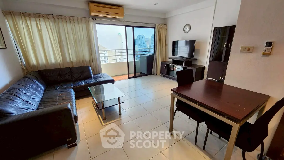 Spacious living room with modern furniture and city view balcony