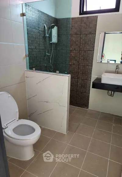 Modern bathroom with shower and toilet in contemporary home