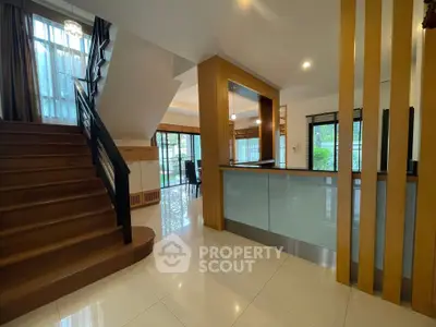 Spacious modern interior with elegant staircase and open layout kitchen