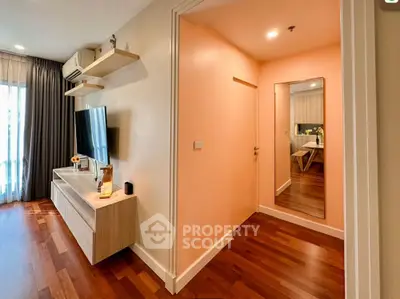 Modern living room with wooden flooring and stylish TV setup