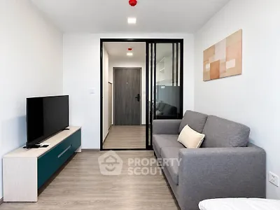 Modern living room with sleek furniture and stylish decor in a contemporary apartment.