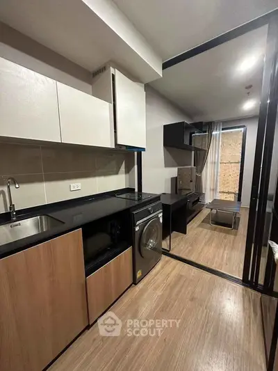 Modern kitchen with sleek cabinetry and built-in appliances in a stylish apartment.