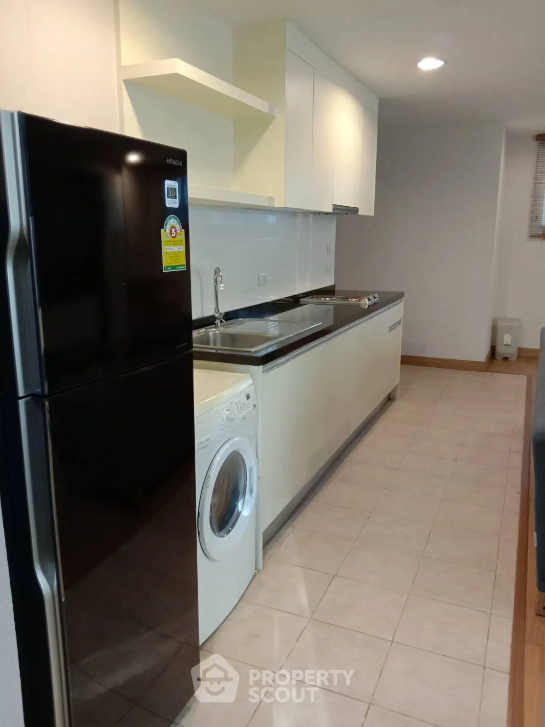 Modern kitchen with sleek appliances and ample counter space in a stylish apartment.