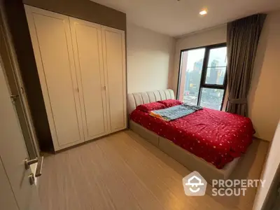 Cozy bedroom with city view, featuring a comfortable bed and spacious wardrobe.