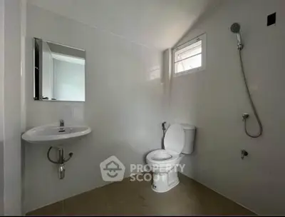 Modern minimalist bathroom with sleek fixtures and natural light.