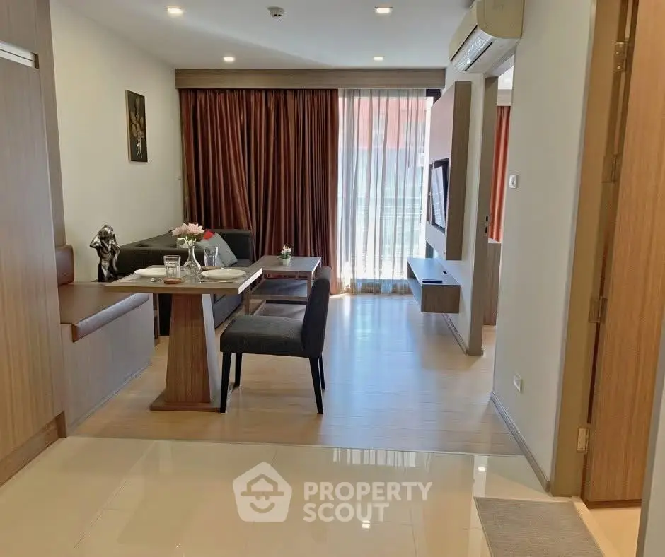 Spacious living room with modern decor and large window for natural light.