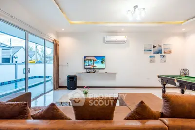 Spacious living room with pool view and modern decor