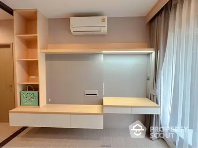 Modern minimalist studio apartment with built-in shelves and ample natural light, perfect for urban living.