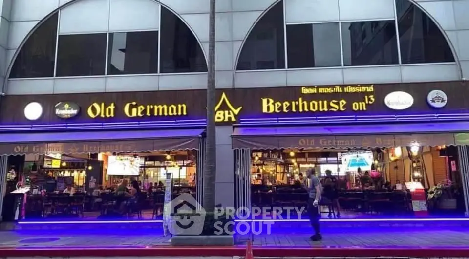 Charming Old German Beerhouse exterior with inviting neon lights and cozy atmosphere.
