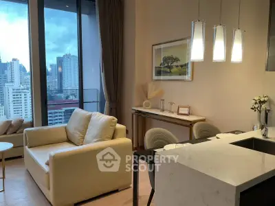 Modern living room with city view, elegant lighting, and cozy seating in a high-rise apartment.