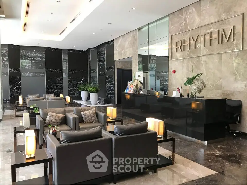 Luxurious modern lobby with elegant seating and marble accents in a high-end building.
