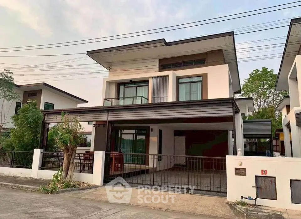 Modern two-story house with sleek design and spacious driveway in a serene neighborhood.