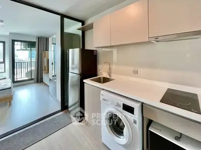 Modern kitchen with washing machine and open layout in stylish apartment