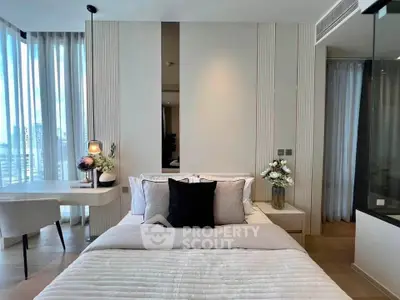 Luxurious modern bedroom with elegant decor and large windows offering natural light.