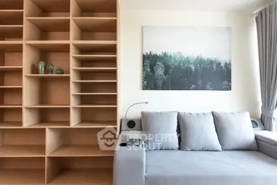 Modern living room with stylish shelving and cozy gray sofa, perfect for relaxation.