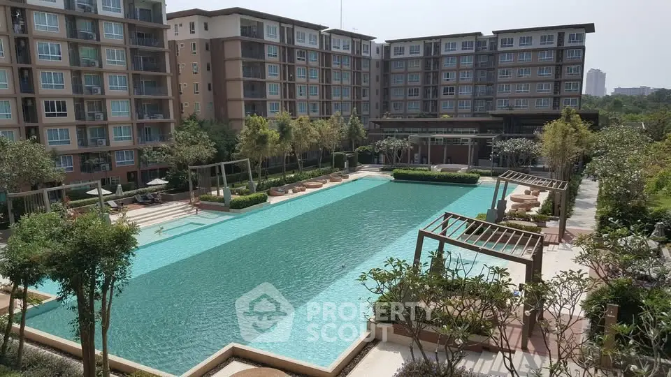 Luxurious apartment complex with a stunning outdoor pool and lush landscaping.