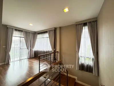Elegant interior with large windows and wooden flooring, perfect for a bright and airy living space.