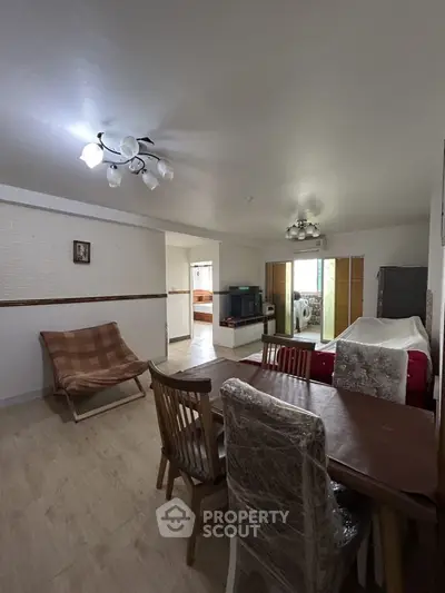 Spacious living room with dining area and modern lighting
