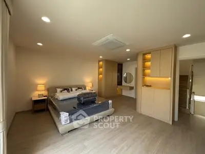 Spacious modern bedroom with elegant lighting and stylish decor