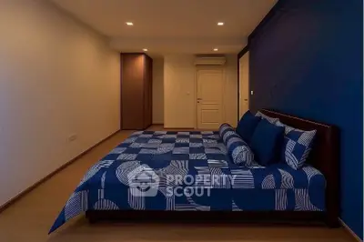 Modern bedroom with stylish blue bedding and minimalist design