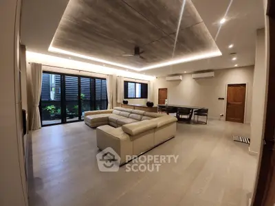 Spacious modern living room with elegant lighting and large windows