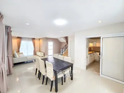 Spacious open-plan living and dining area with modern kitchen in elegant home