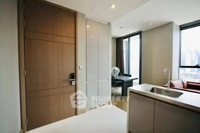 Modern apartment entrance with open kitchen and city view