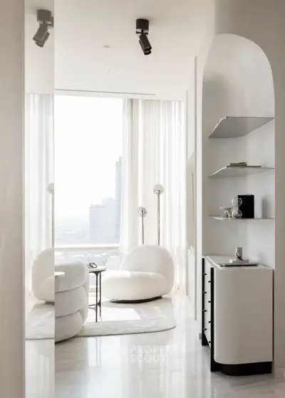 Luxurious modern living room with panoramic city view and elegant white furniture.
