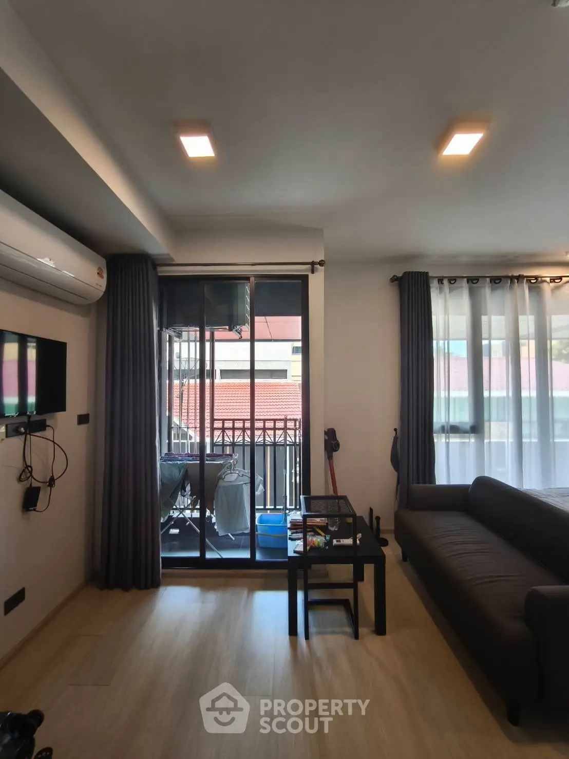 Modern living room with balcony access and stylish decor