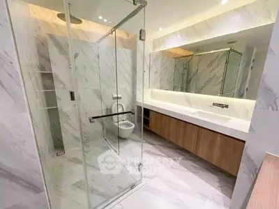 Luxurious modern bathroom with glass shower and elegant marble design