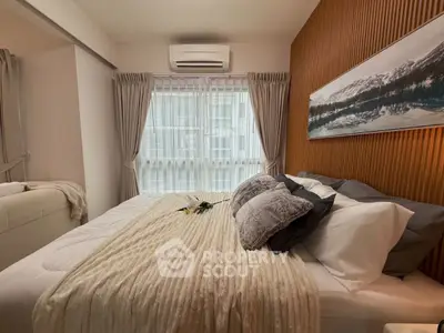 Cozy bedroom with modern decor, featuring a large bed, stylish wall art, and natural light through sheer curtains.