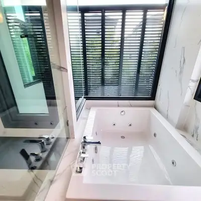Luxurious bathroom with modern bathtub and large window view.