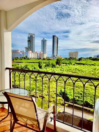 Stunning balcony view of lush greenery and city skyline, perfect for relaxation and urban living.
