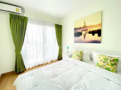 Bright and airy bedroom with large window and stylish decor
