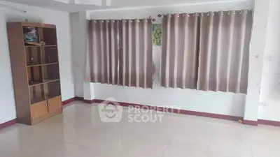Spacious empty room with tiled floor and curtains, ideal for customization.