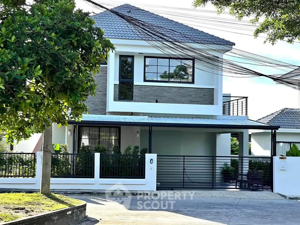 Modern two-story house with spacious driveway and lush greenery