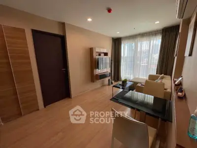 Modern living room with wooden flooring and stylish furniture in a bright apartment.