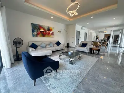 Luxurious modern living room with elegant decor and spacious layout, featuring stylish furniture and ambient lighting.