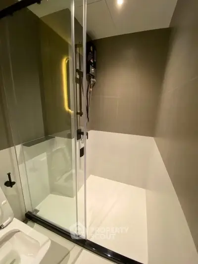Modern bathroom with sleek shower enclosure and contemporary design.