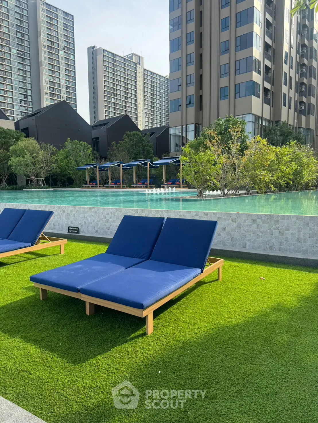 Luxurious poolside view with modern apartment backdrop